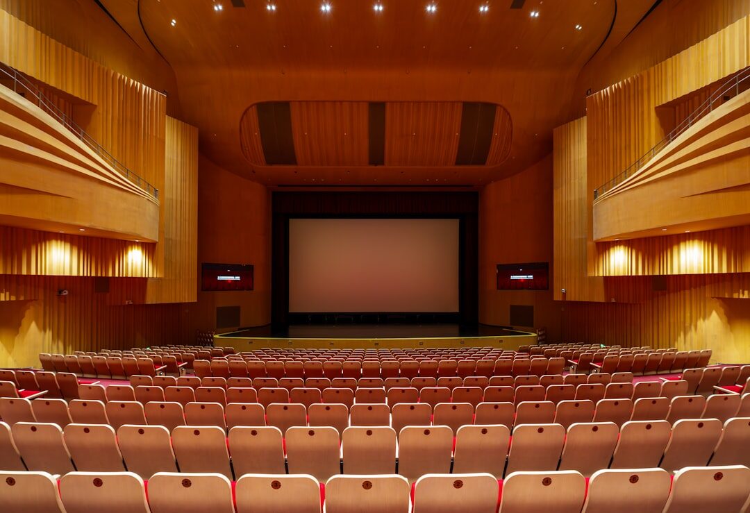 Elegant theatre hall interior with red seats and stage