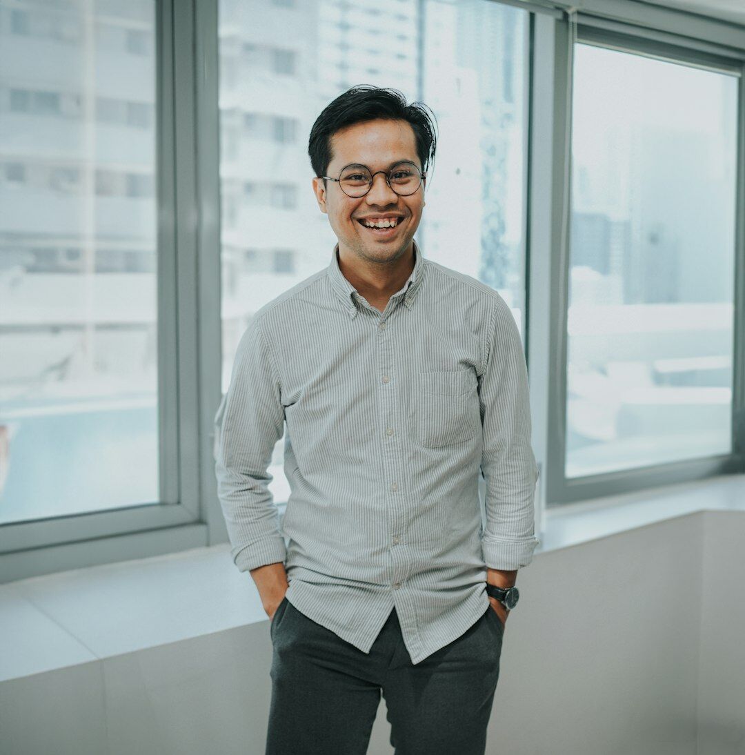 Professional portrait of a friendly middle-aged man with glasses