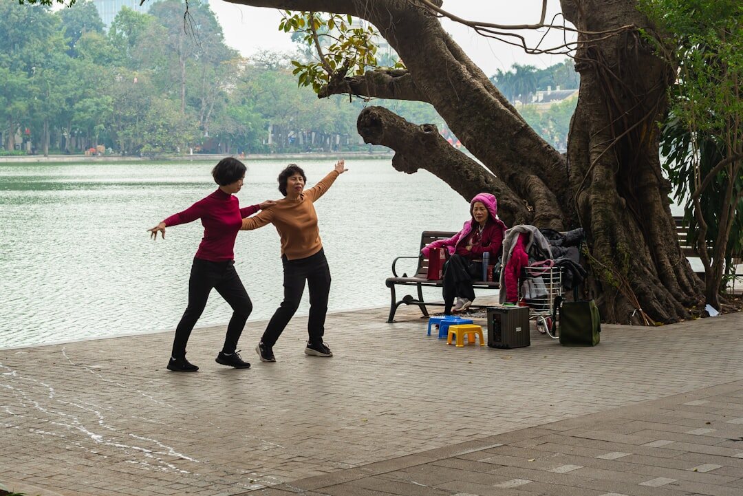 Seniors doing gentle group exercise and stretching outdoors